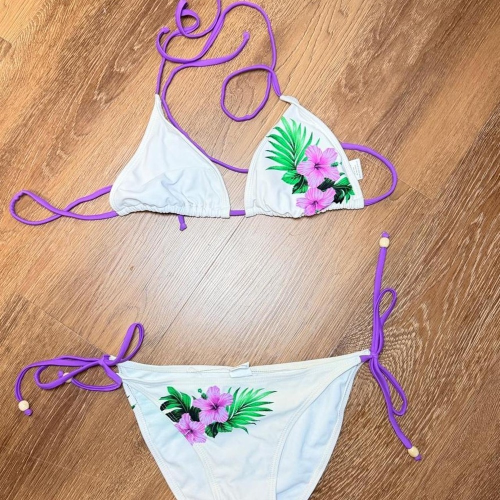 White bikini with purple floral print and green leaves